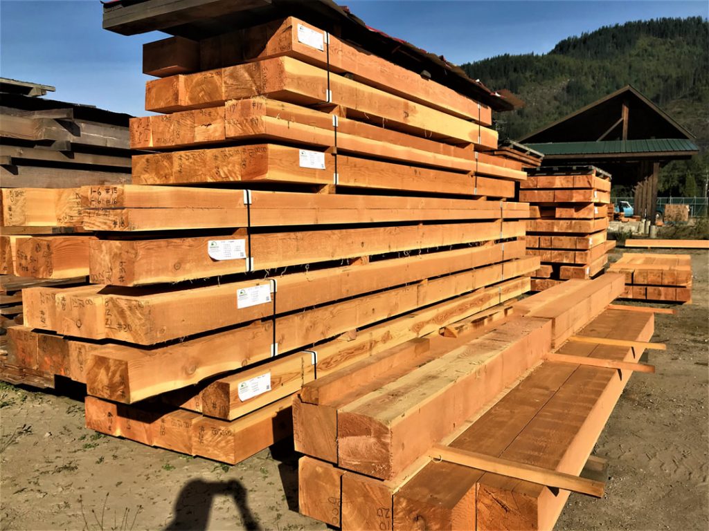 Large custom Douglas fir timbers stacked at Hyde Sawmill
